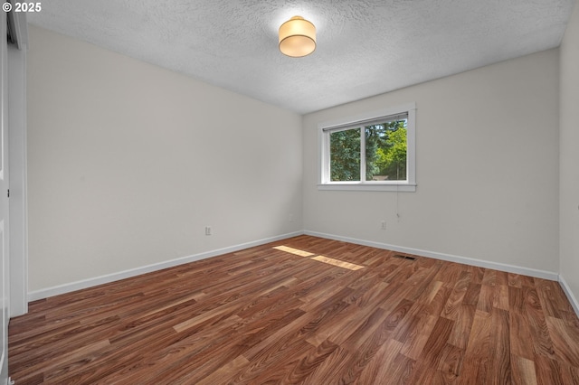 1629 NW Orchard Ave, Gresham, OR 97030 - spare room featuring baseboards, a textured ceiling, and wood finished floors