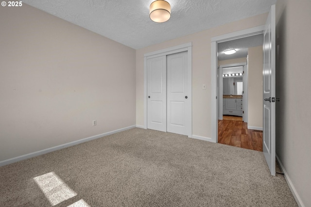1629 NW Orchard Ave, Gresham, OR 97030 - unfurnished bedroom with carpet flooring, a closet, baseboards, and a textured ceiling