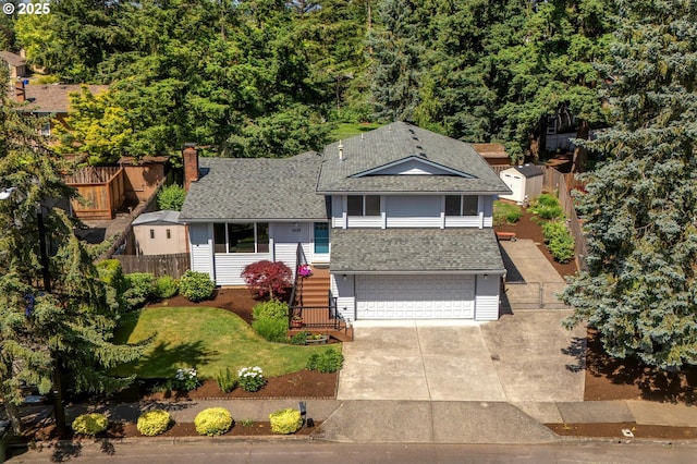 1629 NW Orchard Ave, Gresham, OR 97030 - tri-level home with an attached garage, a shingled roof, a chimney, and concrete driveway