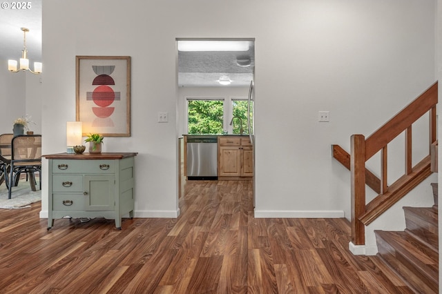 1629 NW Orchard Ave, Gresham, OR 97030 - corridor with dark wood-style flooring, a chandelier, stairs, and baseboards