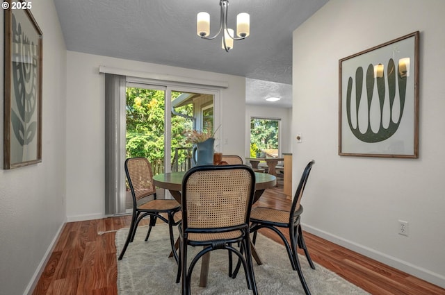 1629 NW Orchard Ave, Gresham, OR 97030 - dining room with baseboards, wood finished floors, a chandelier, and a textured ceiling