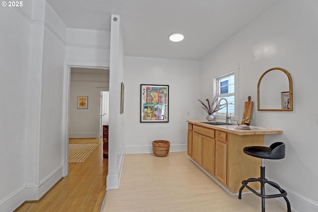 26 NW 22nd Pl, Portland, OR 97210 - bar featuring light wood-type flooring, a sink, and baseboards