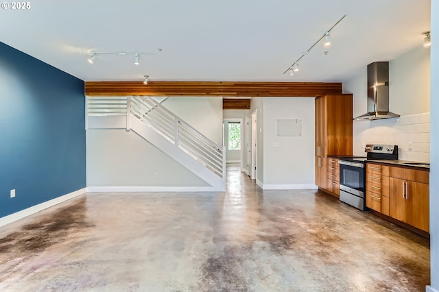 325 NE Graham St Unit 10, Portland, OR 97212 - kitchen with rail lighting, wall chimney range hood, stainless steel range with electric stovetop, and concrete floors