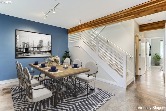325 NE Graham St Unit 10, Portland, OR 97212 - dining area featuring concrete flooring, stairway, rail lighting, and baseboards