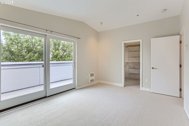 325 NE Graham St Unit 10, Portland, OR 97212 - unfurnished bedroom featuring light colored carpet, lofted ceiling, baseboards, access to outside, and heating unit