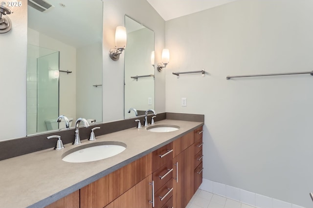 325 NE Graham St Unit 10, Portland, OR 97212 - bathroom featuring double vanity, tile patterned flooring, and toilet