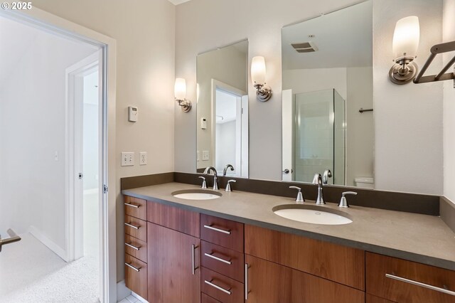 325 NE Graham St Unit 10, Portland, OR 97212 - full bathroom with double vanity, toilet, and a shower with shower door