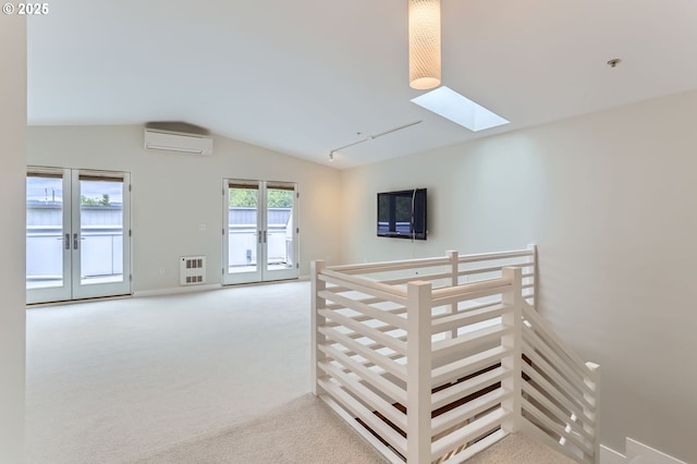 325 NE Graham St Unit 10, Portland, OR 97212 - hallway featuring an AC wall unit, french doors, a skylight, vaulted ceiling, and heating unit