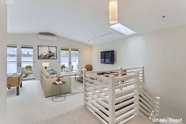 325 NE Graham St Unit 10, Portland, OR 97212 - living room with a wall unit AC, a skylight, lofted ceiling, and carpet