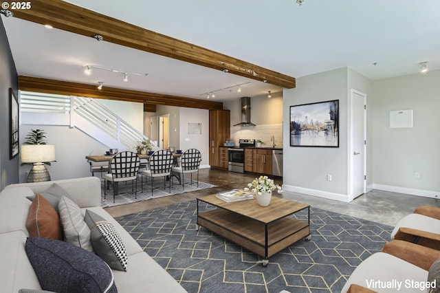 325 NE Graham St Unit 10, Portland, OR 97212 - living room featuring rail lighting, baseboards, and concrete floors