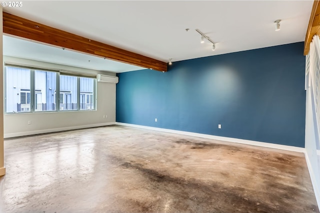 325 NE Graham St Unit 10, Portland, OR 97212 - empty room featuring concrete floors, track lighting, a wall unit AC, and baseboards
