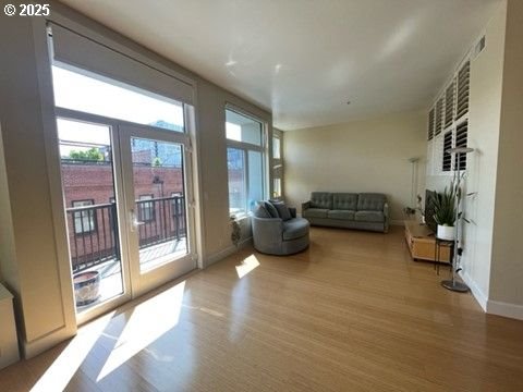 618 NW 12th Ave Unit 311, Portland, OR 97209 - living area featuring wood finished floors, healthy amount of natural light, and baseboards