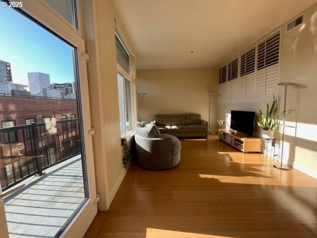 618 NW 12th Ave Unit 311, Portland, OR 97209 - living room with a fireplace, a city view, wood finished floors, and baseboards