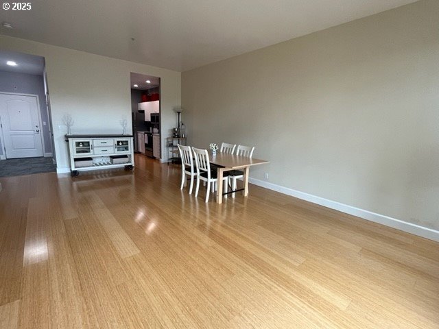 618 NW 12th Ave Unit 311, Portland, OR 97209 - dining area with wood finished floors and baseboards