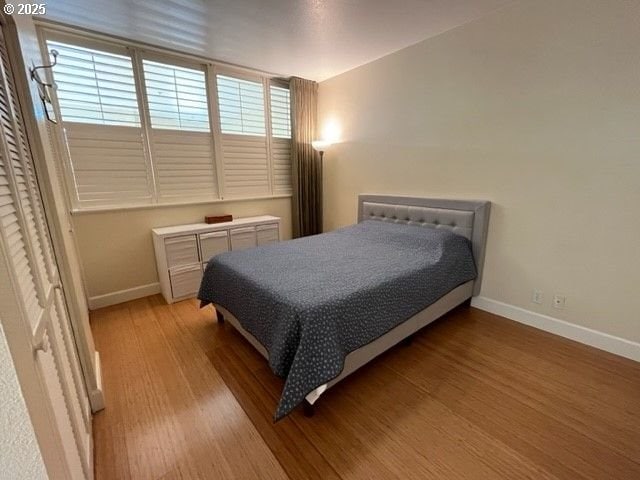 618 NW 12th Ave Unit 311, Portland, OR 97209 - bedroom featuring baseboards and light wood-style floors