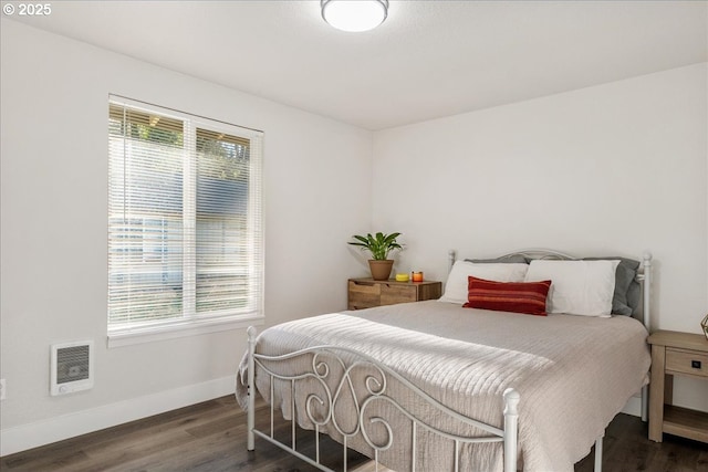 bedroom with dark hardwood / wood-style flooring