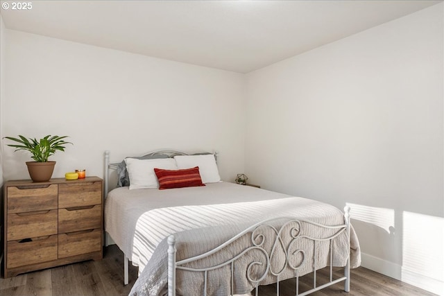 bedroom with hardwood / wood-style floors