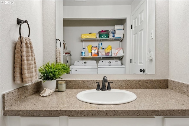 bathroom with vanity and separate washer and dryer