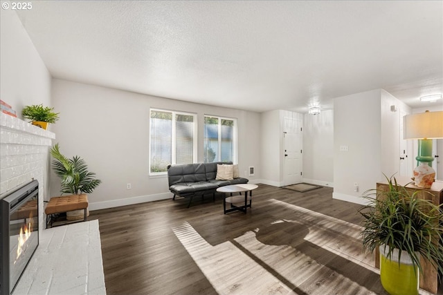 living room featuring a fireplace and dark wood-type flooring