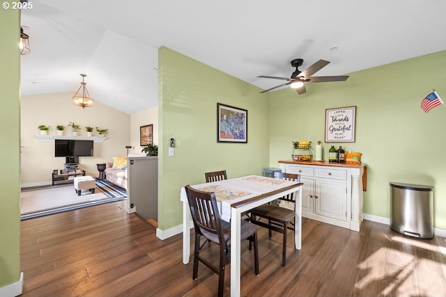 dining room with vaulted ceiling, ceiling fan, and dark hardwood / wood-style flooring