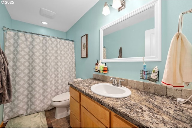 bathroom with toilet and vanity