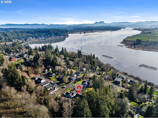 birds eye view of property featuring a water and mountain view