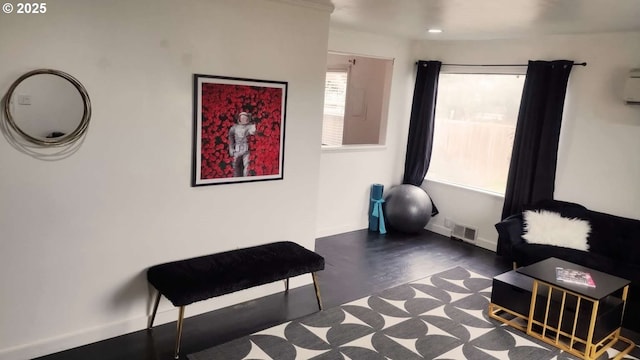 living area featuring visible vents and baseboards