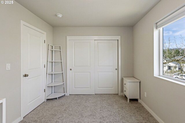 1466 N Steiwer Ln, Newberg, OR 97132 - unfurnished bedroom featuring a closet, light colored carpet, and baseboards