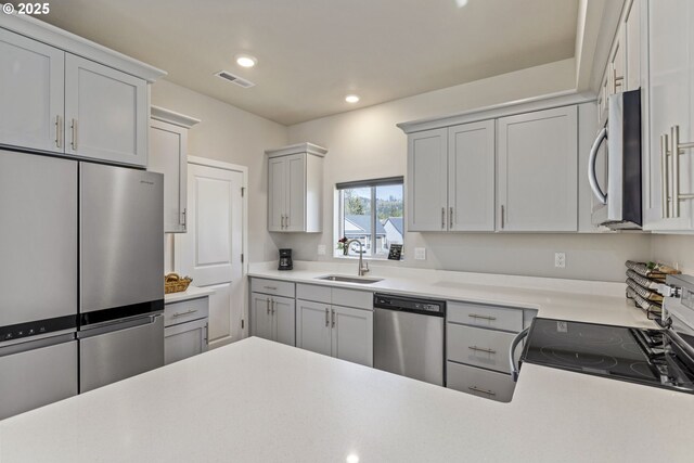 1466 N Steiwer Ln, Newberg, OR 97132 - kitchen featuring visible vents, a sink, light countertops, recessed lighting, and stainless steel appliances