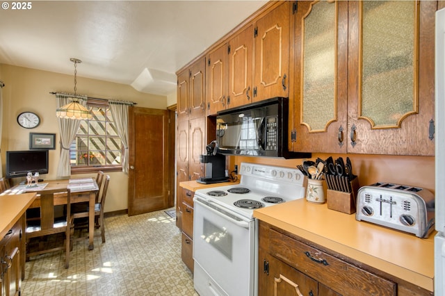 kitchen with white electric range, black microwave, light countertops, and brown cabinets