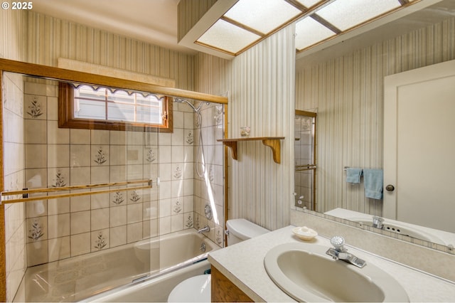 full bathroom featuring wallpapered walls, toilet, enclosed tub / shower combo, and vanity