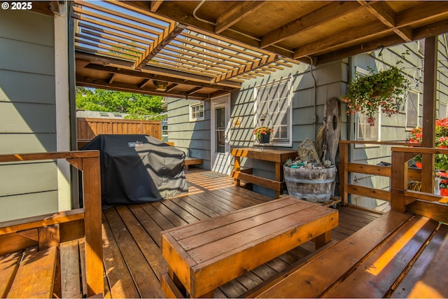 wooden terrace with fence and a grill