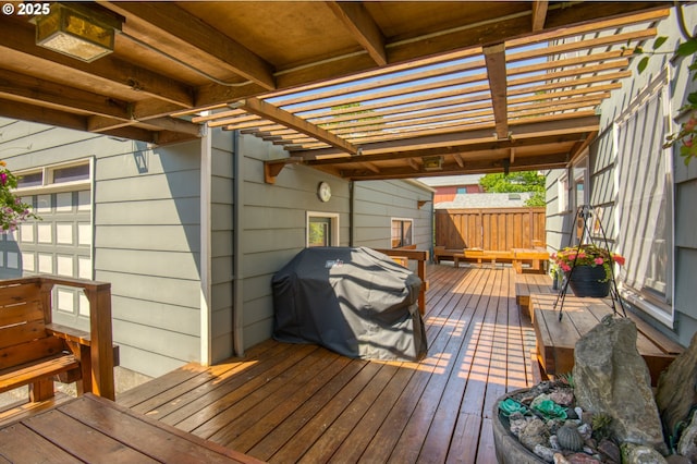 wooden terrace featuring a grill and a pergola