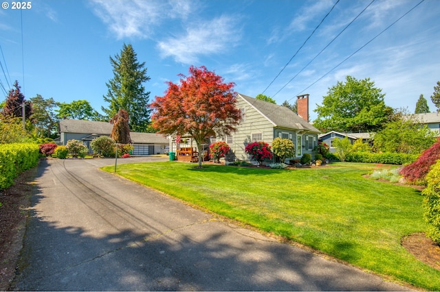 view of front of home featuring a front yard and a chimney