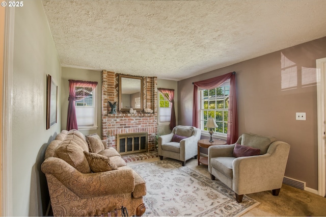 living area with a textured ceiling, healthy amount of natural light, light colored carpet, a brick fireplace, and baseboards