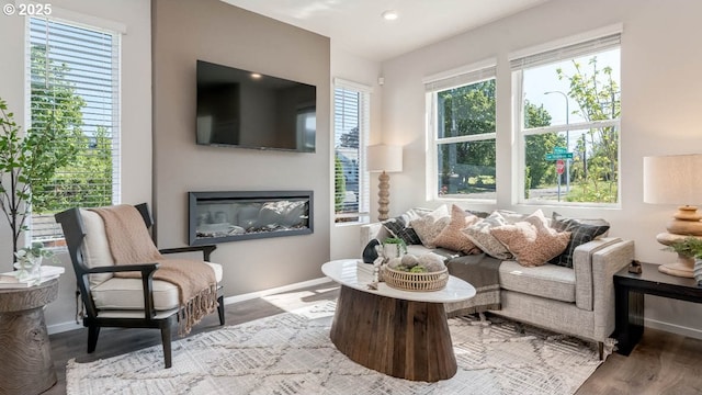 3447 SW Thomas Ave, Gresham, OR 97080 - living area featuring a glass covered fireplace, wood finished floors, and recessed lighting