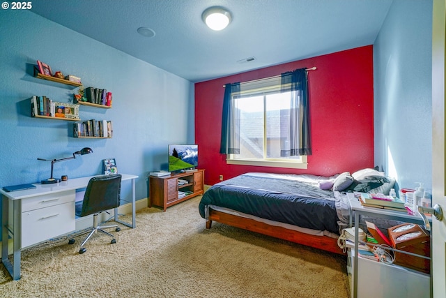 carpeted bedroom featuring visible vents and baseboards