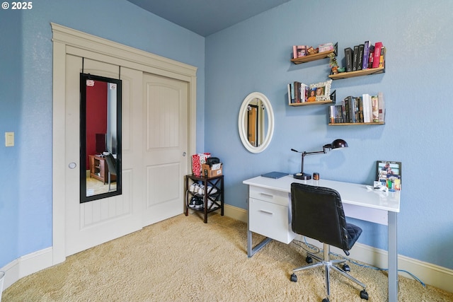 office featuring baseboards and light colored carpet