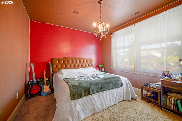 carpeted bedroom featuring baseboards, a textured ceiling, visible vents, and a notable chandelier