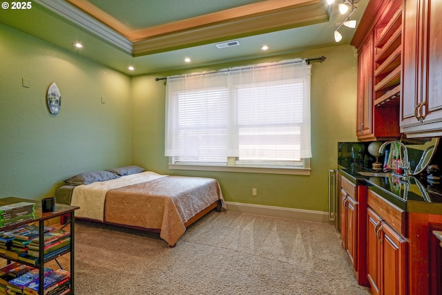 bedroom with baseboards, visible vents, a raised ceiling, light colored carpet, and ornamental molding