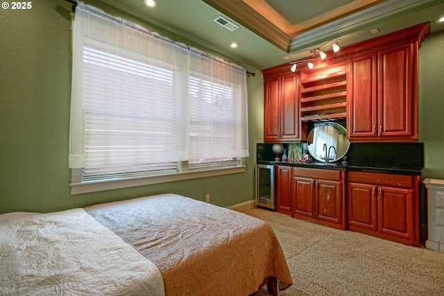 carpeted bedroom featuring ornamental molding, wine cooler, multiple windows, and visible vents