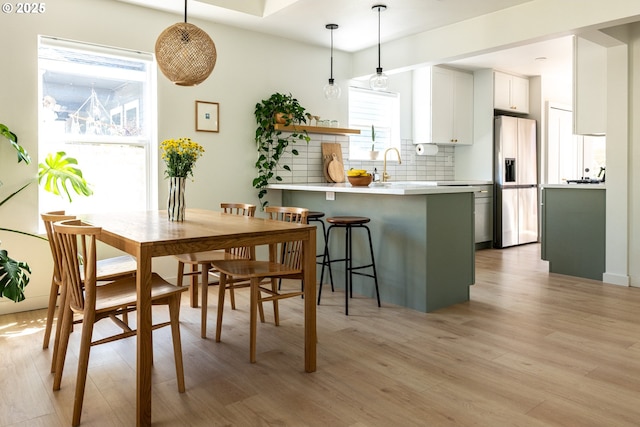 dining area featuring light wood finished floors