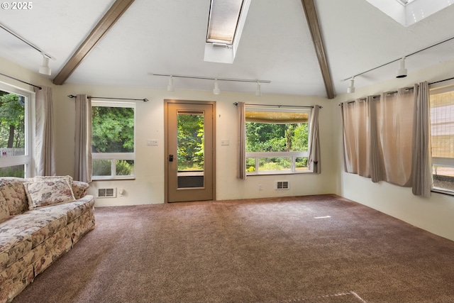 12791 Sutherland Rd, Swisshome, OR 97480 - carpeted living room featuring track lighting, a skylight, healthy amount of natural light, and beamed ceiling