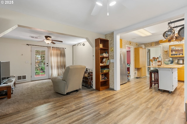 12791 Sutherland Rd, Swisshome, OR 97480 - living room with ceiling fan, light wood-type flooring, and arched walkways