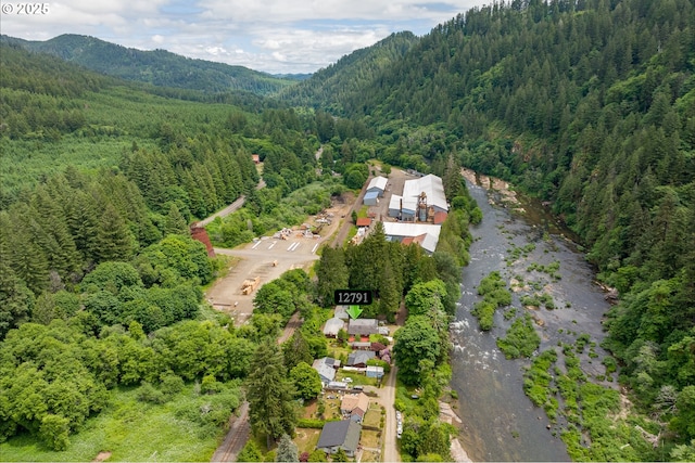 12791 Sutherland Rd, Swisshome, OR 97480 - aerial overview of property's location with a heavily wooded area and mountains