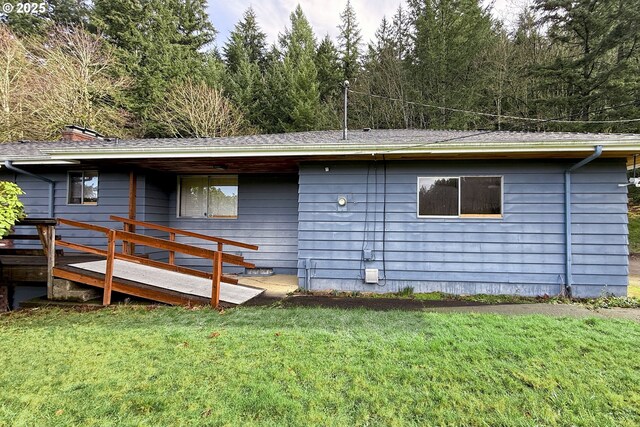 rear view of property featuring a yard