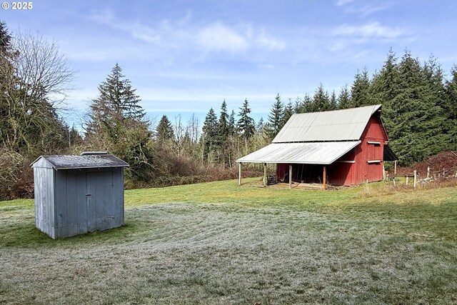 view of yard with a barn and an outbuilding