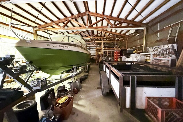 miscellaneous room with concrete floors and lofted ceiling