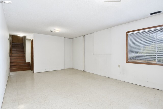 interior space with tile patterned floors, stairs, and visible vents