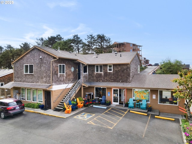 107 Sunset Blvd, Cannon Beach, OR 97110 - view of property featuring uncovered parking and stairs